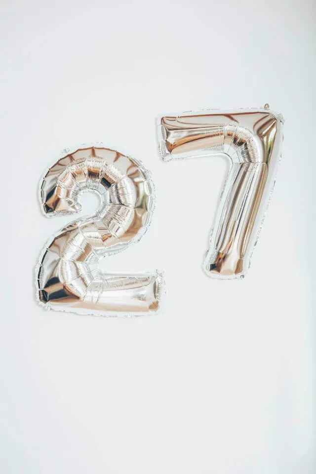 Two silver balloons with the shape of a two and a seven