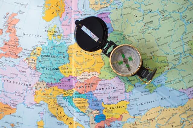 A compass with the sea in the background